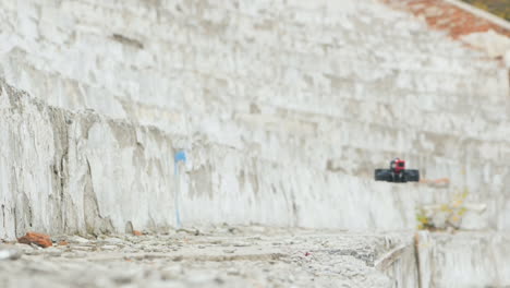 Drone-For-Racing-Low-Flies-Along-A-Concrete-Wall