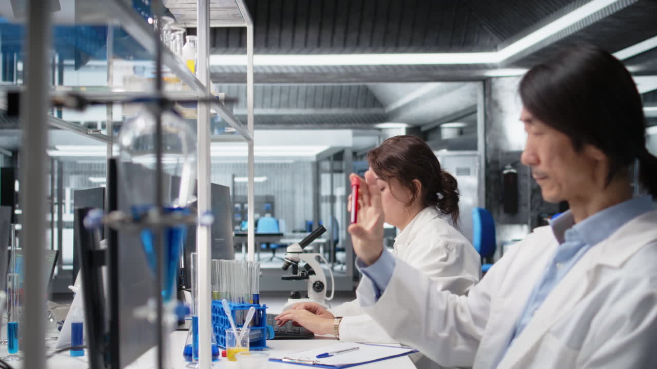 Vertical video Medical laboratory technician checking time, waiting to finish shift