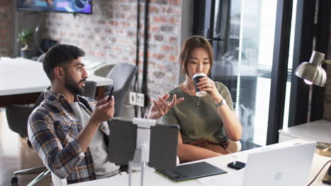 Young-Asian-man-and-Asian-woman-are-collaborating-in-a-modern-office-setting-on-their-business-work