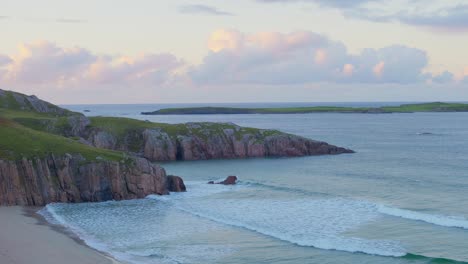 Peaceful afternoon at Ceannabeinne Beach, Durness. Dramatic clouds, small waves, green cliffs and calm ocean views along the scenic Scottish coastline