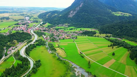 revealing drone shot of scenic alpine town of garmisch-partenkirchen, germany