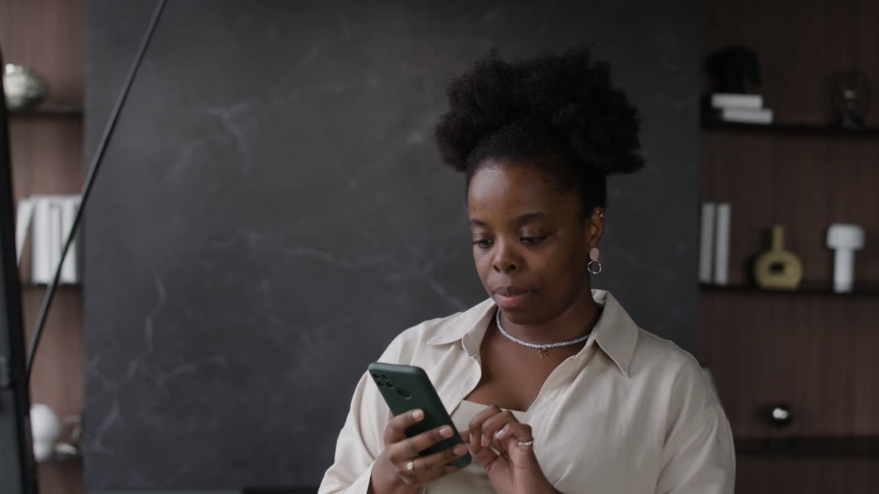 Woman using phone indoors