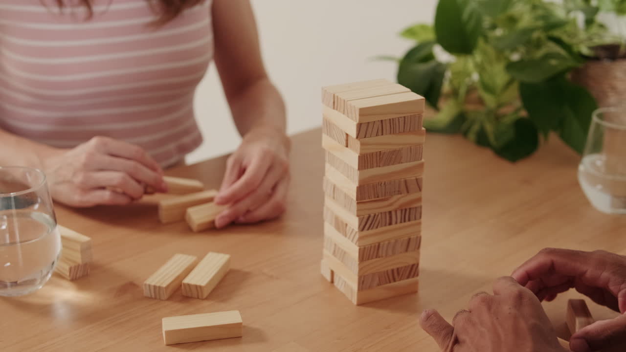 Couple Plays Jenga at Home