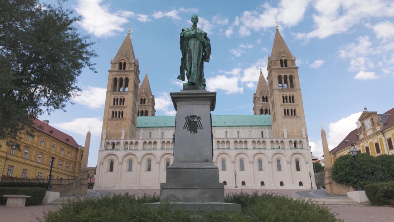 View of the Statue of Ignác Szepesy with Pécs Cathedral behind, highlighting historic architecture and sculptural artistry