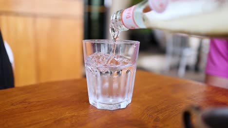 a glass being filled with water
