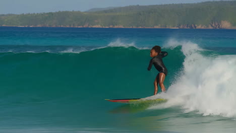 young person surfing on a bright tropical ocean wave