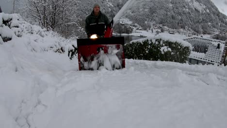 still shot man cleaning snow covered road with snowplow - blizzard scenery