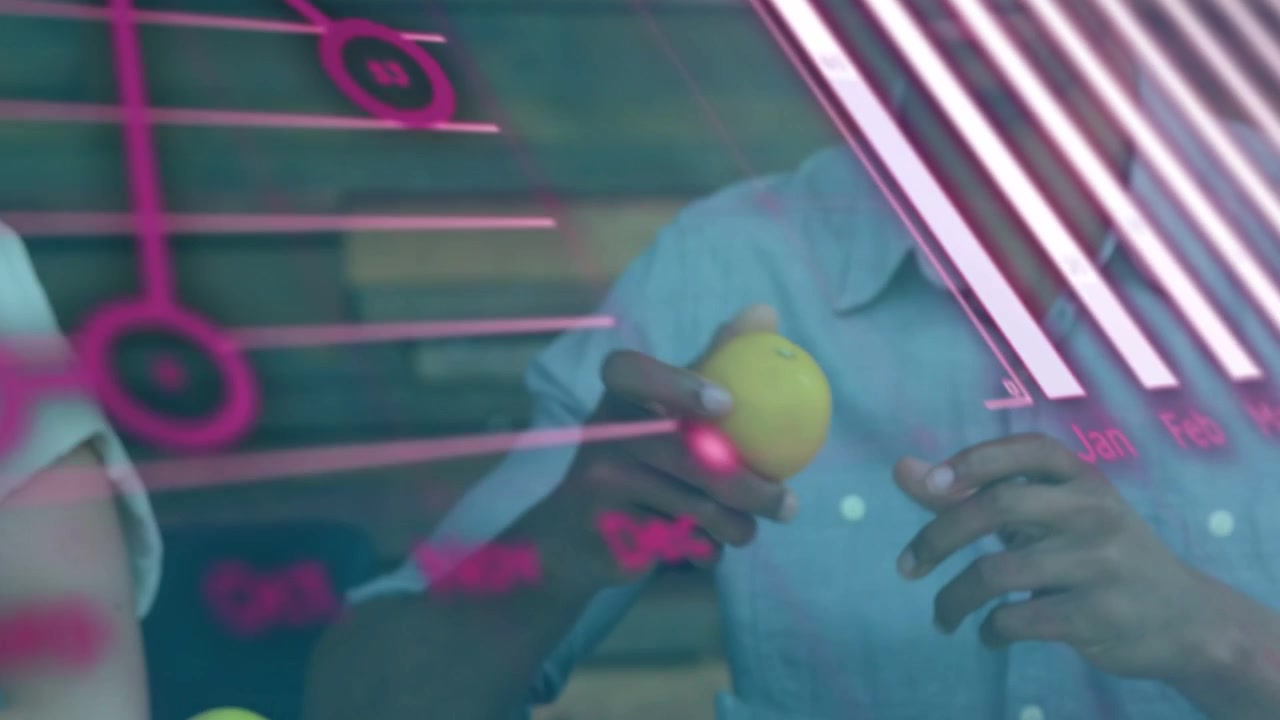 Left reaching for apple, right man receiving and inspecting it during food pink data charts overlay