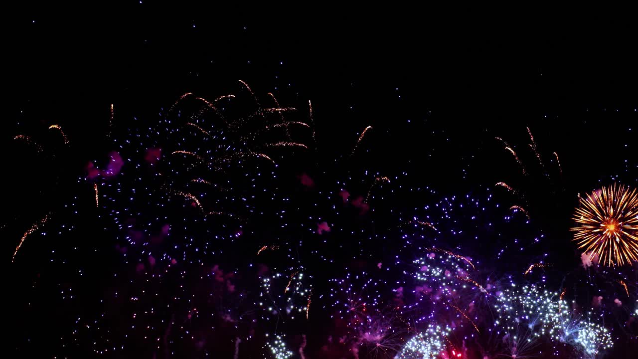 Colorful fireworks exploding in the night sky. Celebrations and events in bright colors.