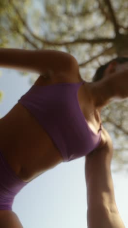 woman exercising outdoors with a kettlebell