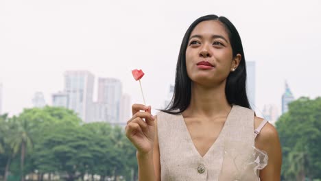 woman eating watermelon in the park