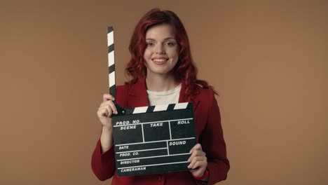 woman holding clapperboard