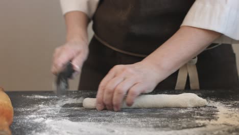 making meat dumpling with wooden rolling pin.