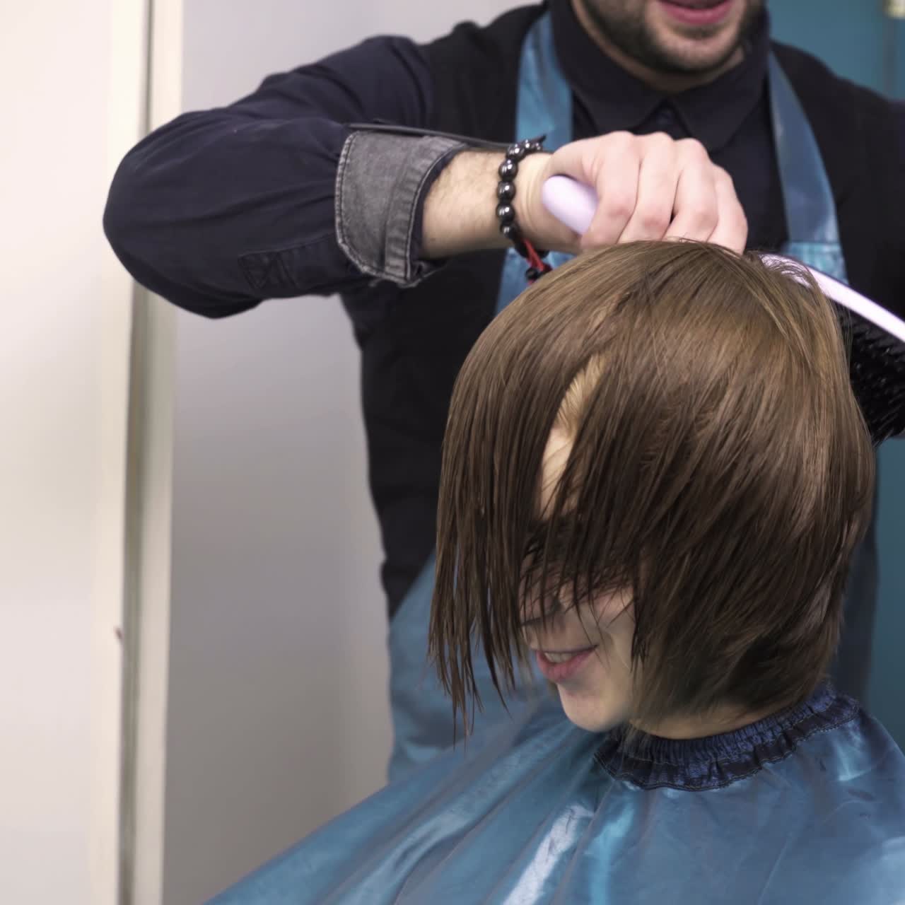 Professional hairdresser cutting hair