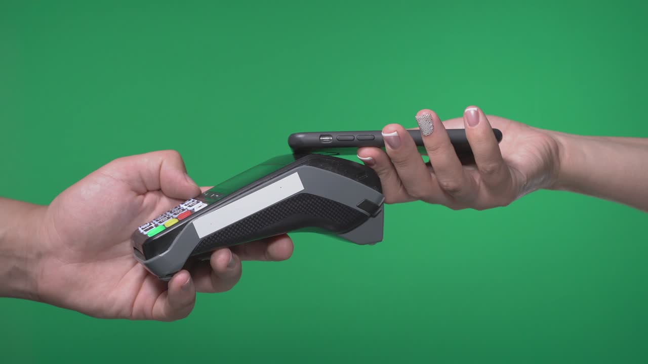 Close up male hold in hand wireless modern bank payment terminal to process acquire credit phone payments isolated on green screen. Copy space mock up advertising, girl pay