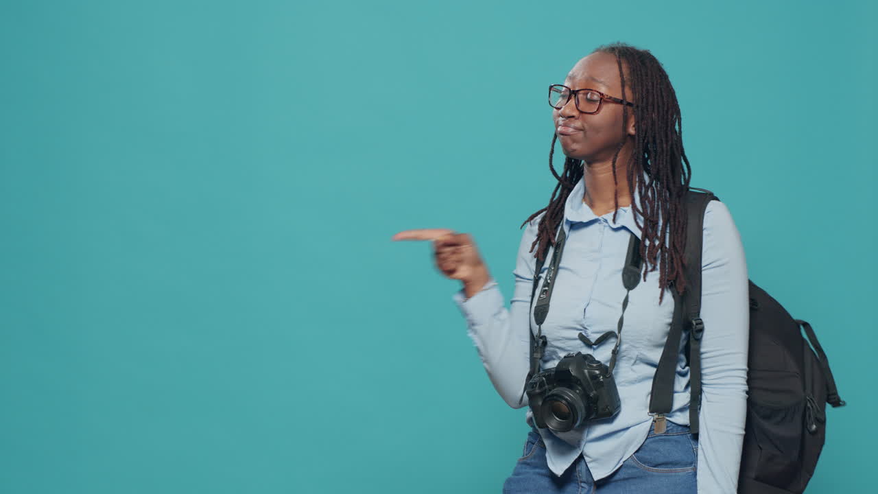 Photographer pointing at left and right side in studio