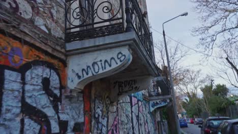 handheld walking shot of old abandoned building with graffiti oart on the exterior, located at kifissia, greece