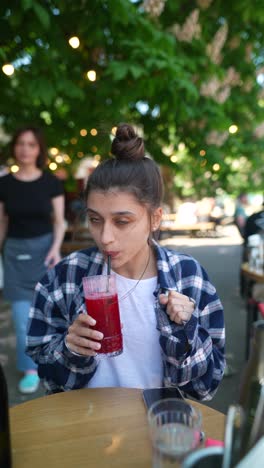 woman enjoying a drink outdoors