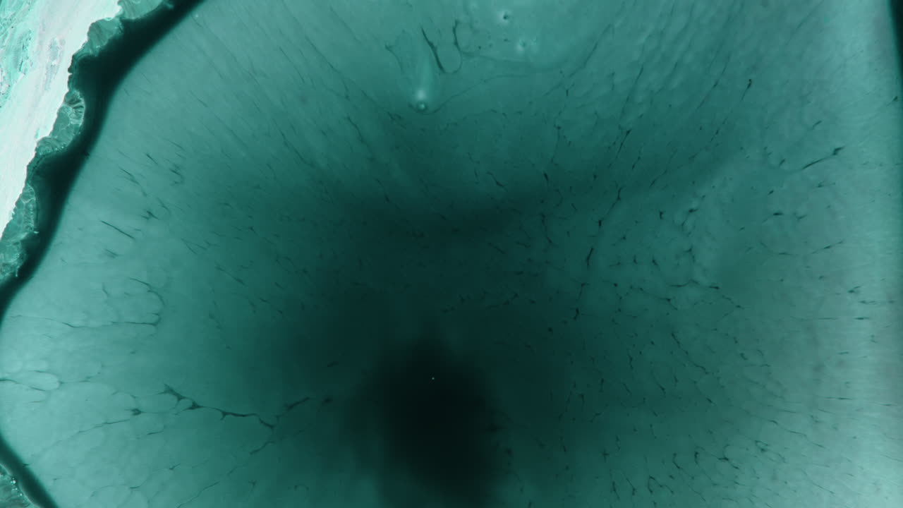 Macro shot of liquids merging, showcasing fluid dynamics concepts