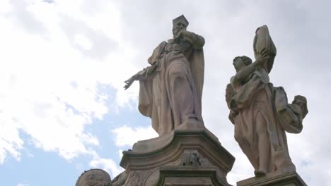 historical stone statues against a cloudy sky