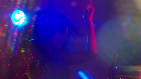 close up of two women in nightclub bar or disco dancing with sparkling lights 15