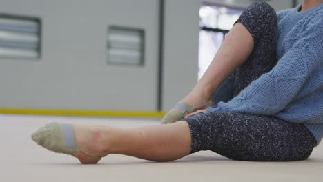 teenage female gymnast performing at sports hall