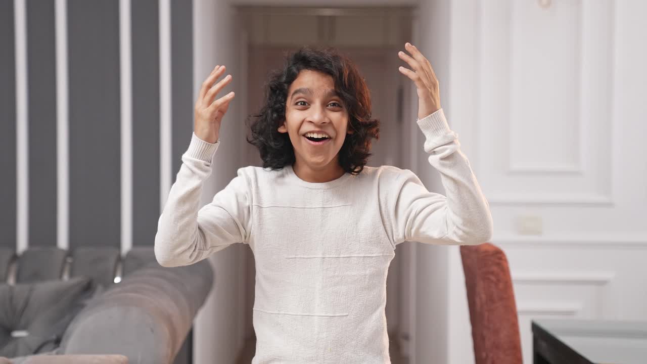 Surprised Indian kid teenager boy smiling