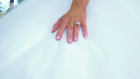 caucasian bride in her wedding dress wearing her elegant diamond ring