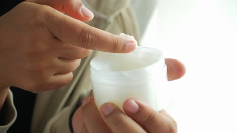 person applying hand cream