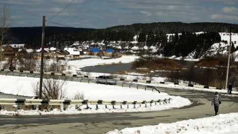 snowy country road by a river