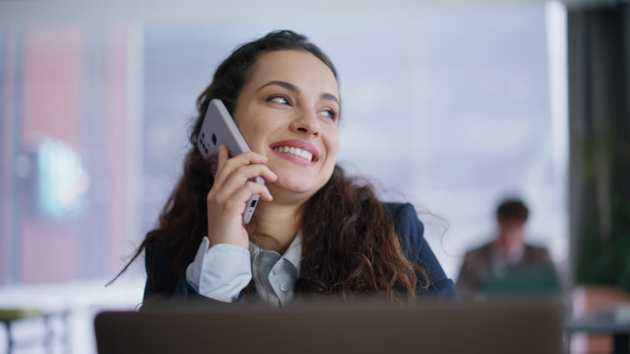 Laughing ceo calling cellphone flipping report documents at coworking closeup