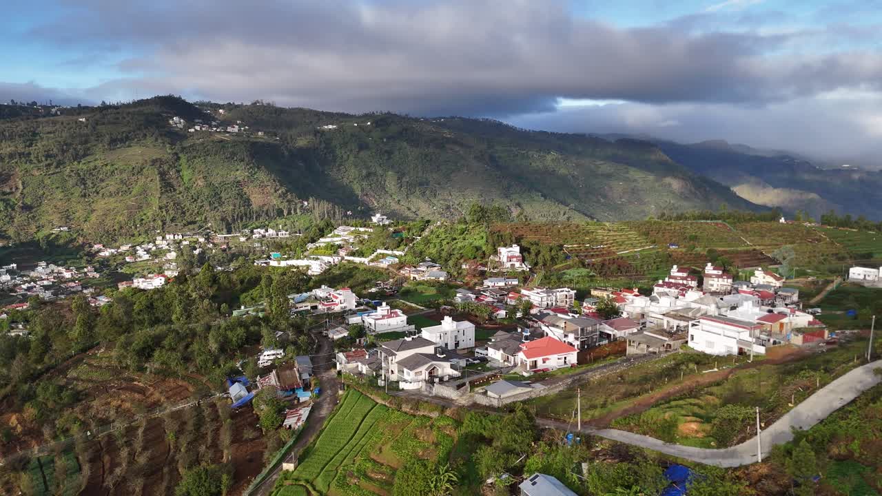 Aerial cinematic view showing elevation and dense mountain life