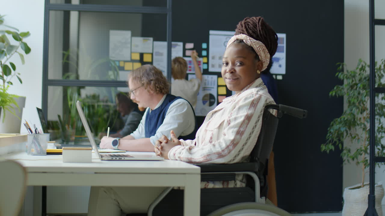 Portrait of Black Woman in Wheelchair at Office Workplace