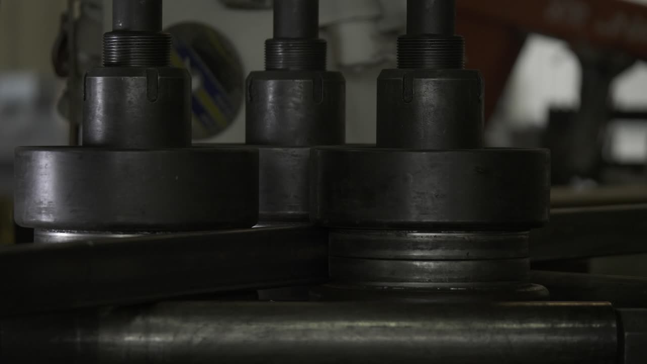 Metal bending mastery: Watch a machine gracefully shape construction elements in this vivid stock footage, showcasing industrial precision
