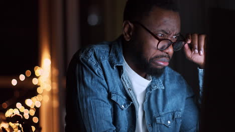 man concentrating on computer at night