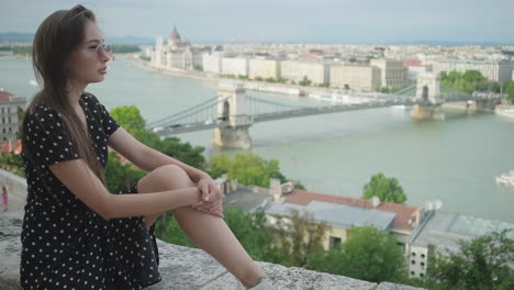 woman enjoying the view of budapest from a hilltop