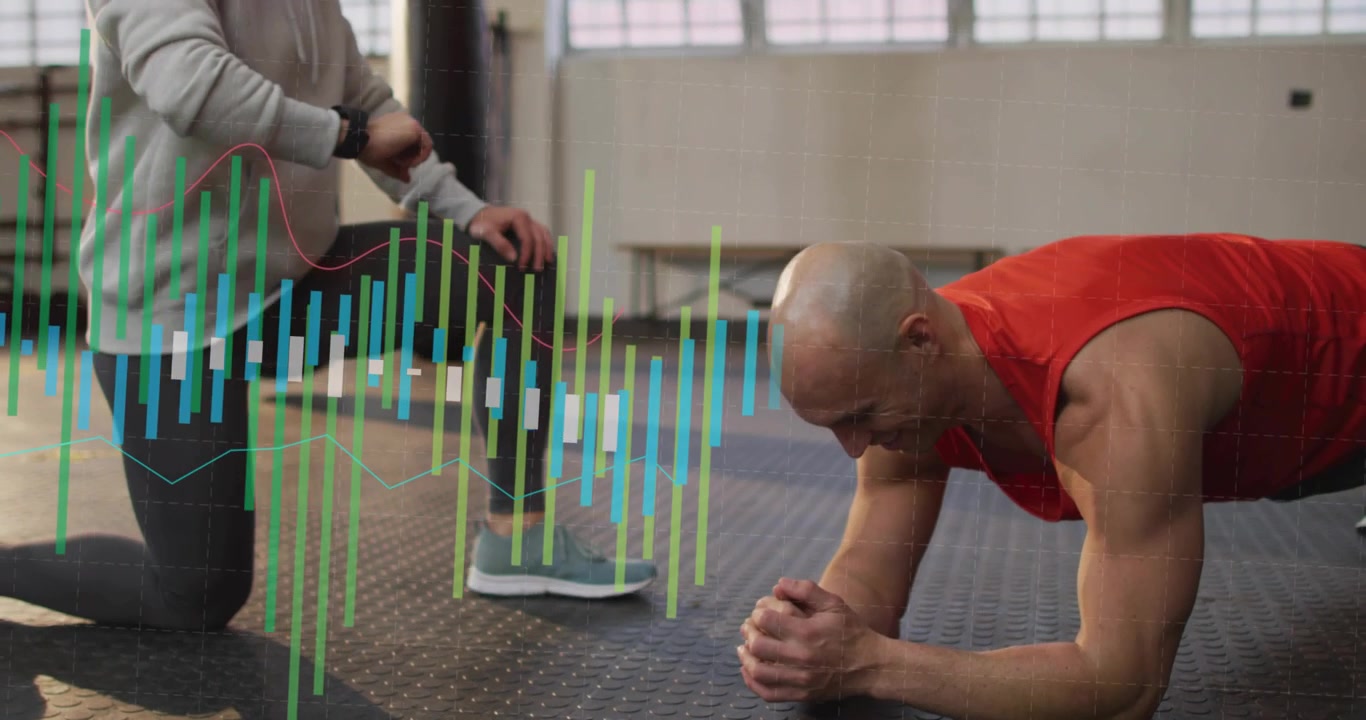Coach checking watch on knee starting data bars across gym trainee holding forearm plank for timing
