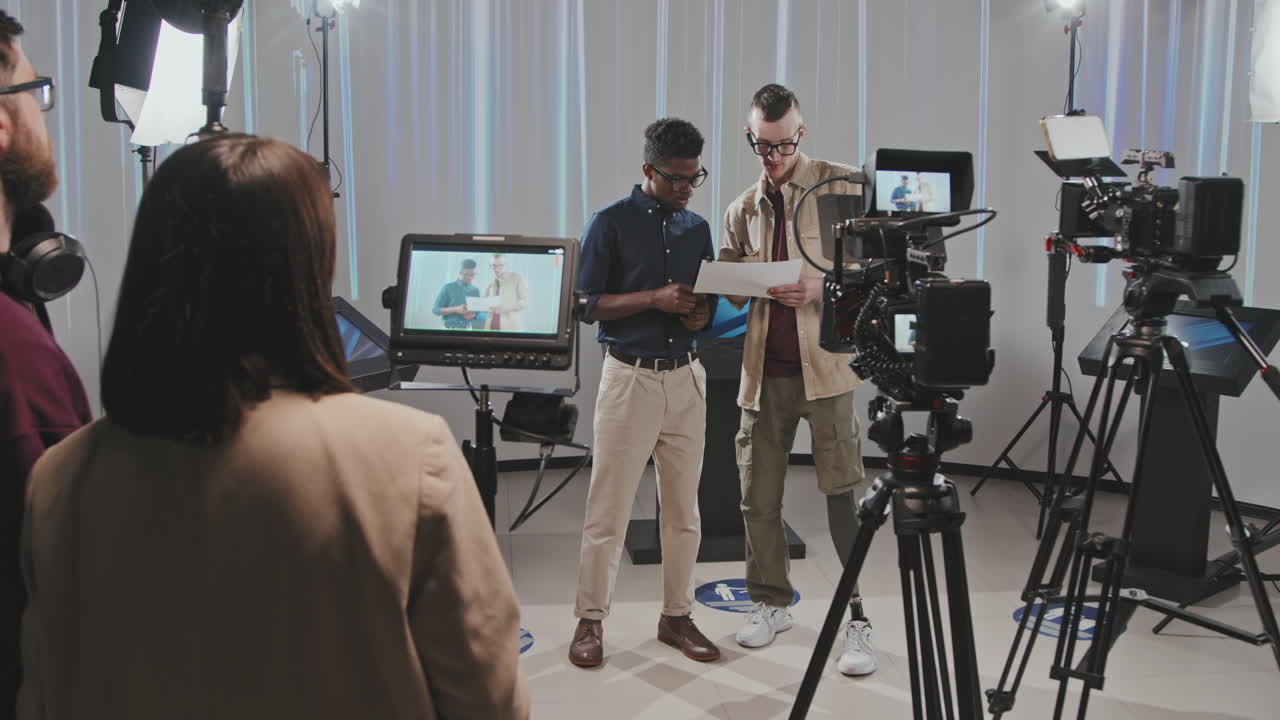 Operator With Prosthetic Leg Discussing Storyboard With Man In Studio
