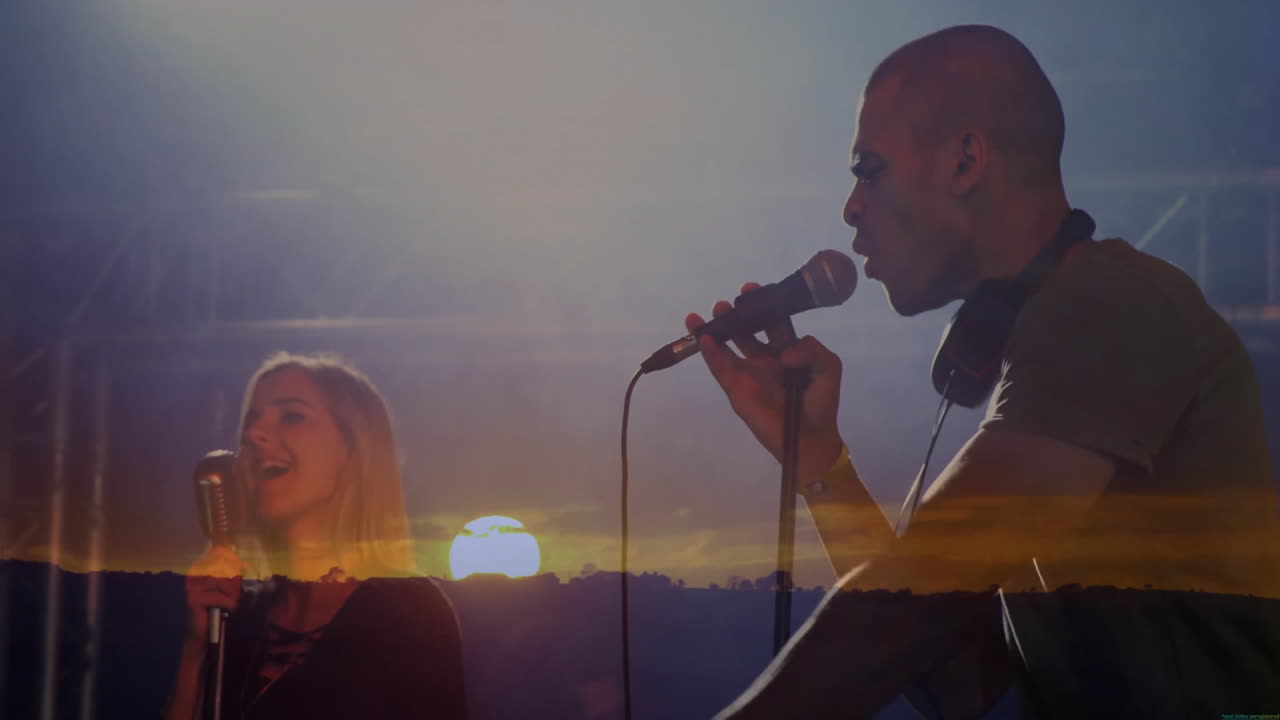 musical duo performing on sunset stage with vintage microphones and lighting for music promotion