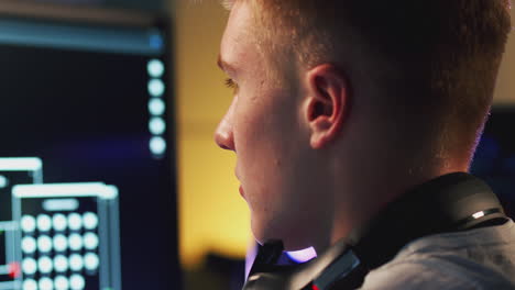 Male-Teenage-Hacker-Sitting-In-Front-Of-Computer-Screens-Bypassing-Cyber-Security