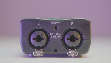 close-up of a stereo audio interface with external microphone and line input connections