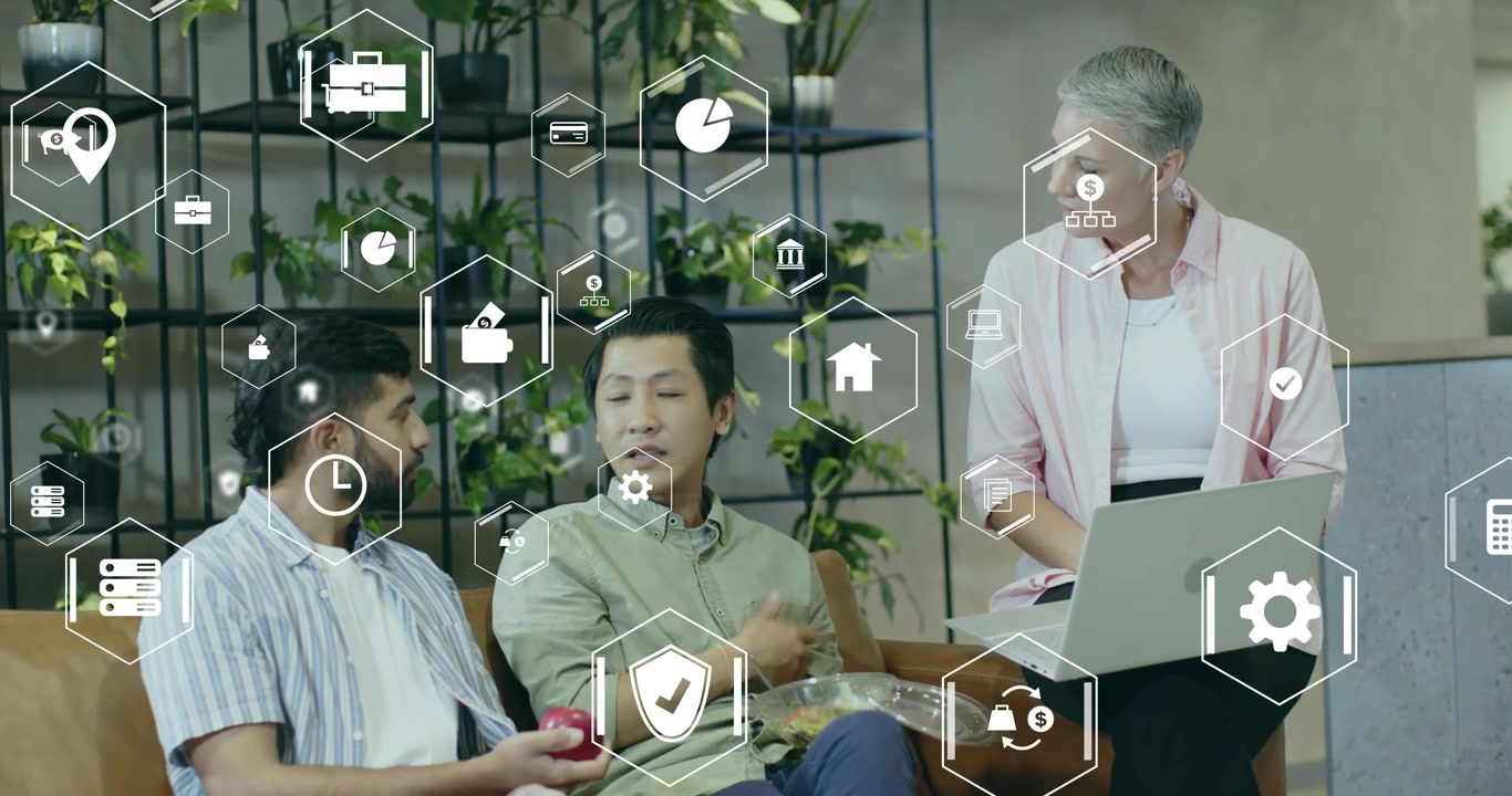 Colleagues tapping laptop trackpad and pointing at floating hex icons while reviewing tech project