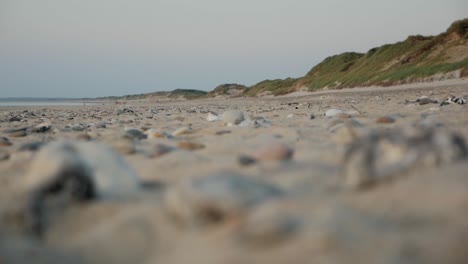 stones lying on a beach with focus pulled from stones to background