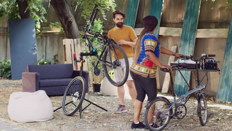 couple rectifying bicycles in home yard