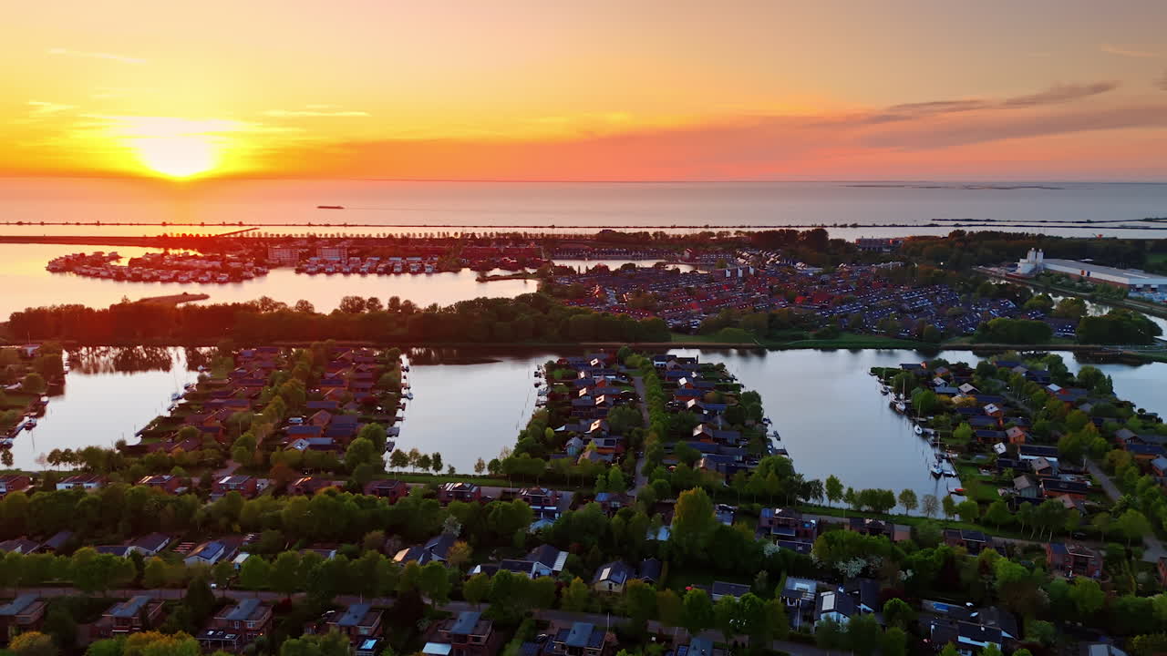 Village on the water with lots of greenery. Vinkeveen, the Netherlands in the light of beautiful sunset. Aerial view.