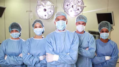 Surgical-team-looking-at-the-camera-in-operating-theater