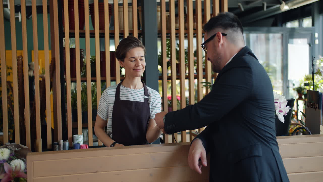 Customer purchasing flowers at a floral shop