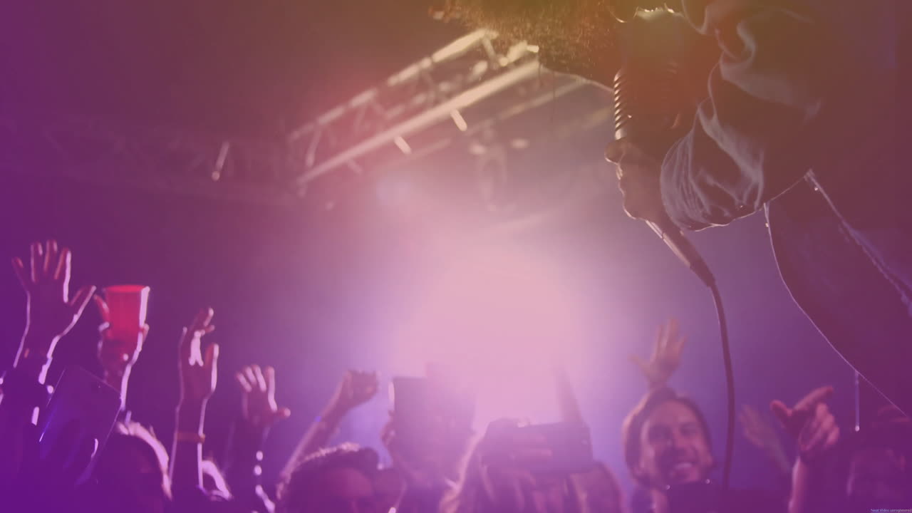 Male performer leaning toward fans in music concert, showing animated smartphone icons