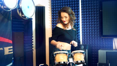 beautiful woman dances playing drums.