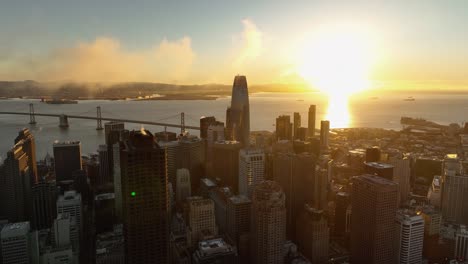 san francisco bay and skyline at dawn golden hour with fluffy clouds above city